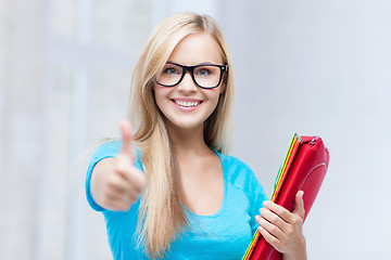 Image showing smiling student with folders