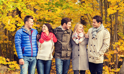 Image showing group of smiling men and women in autumn park