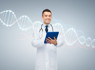 Image showing happy male doctor with tablet pc and dna molecule