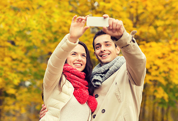 Image showing smiling couple hugging in autumn park