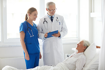 Image showing doctor and nurse visiting senior woman at hospital