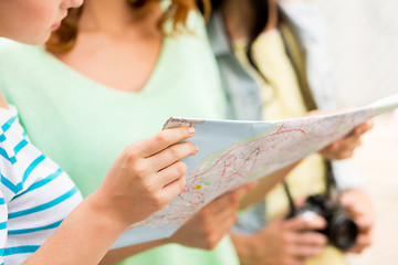 Image showing close up of women with map and camera outdoors