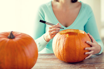 Image showing close up of woman with pumpkins at home