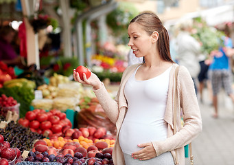 Image showing pregnant woman choosing food at street market