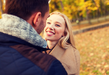 Image showing smiling couple hugging in autumn park