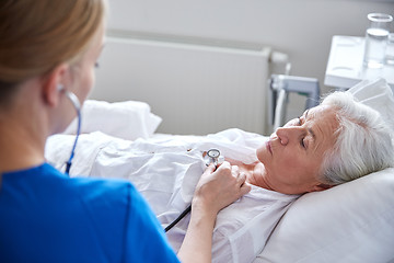 Image showing nurse with stethoscope and senior woman at clinic