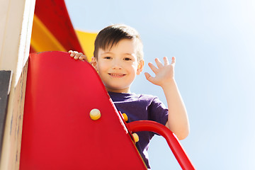 Image showing happy little boy climbing on children playground