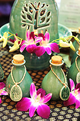 Image showing Bottles of herbal spa oils and flowers.