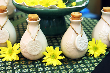 Image showing Bottles of herbal spa oils and flowers.