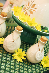 Image showing Bottles of herbal spa oils and flowers.