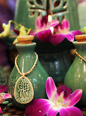 Image showing Bottles of herbal spa oils and flowers.