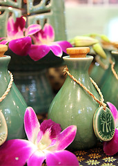 Image showing Bottles of herbal spa oils and flowers.