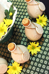 Image showing Bottles of herbal spa oils and flowers.