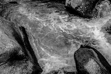 Image showing river stream flowing over rock formations in the mountains