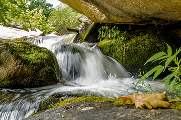 Image showing river stream flowing over rock formations in the mountains