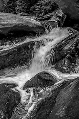 Image showing river stream flowing over rock formations in the mountains