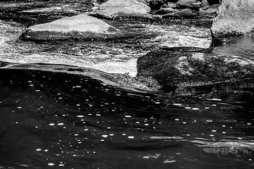 Image showing river stream flowing over rock formations in the mountains