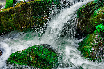 Image showing river stream flowing over rock formations in the mountains