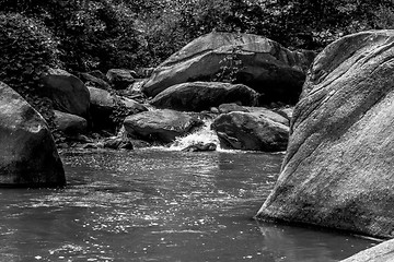 Image showing river stream flowing over rock formations in the mountains