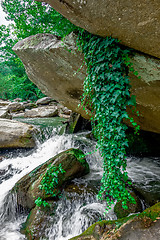 Image showing river stream flowing over rock formations in the mountains