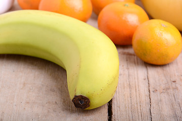 Image showing Fresh colorful fruits composition mandarin, bananas and orange