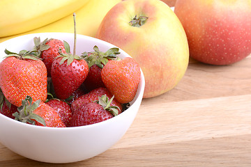 Image showing Close-up shot of variety of fruits on old wooden plate