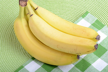 Image showing Bunch of ripe bananason green material background