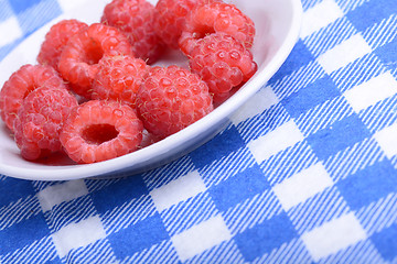 Image showing Fresh raspberries. Closeup of fruits on a white plate