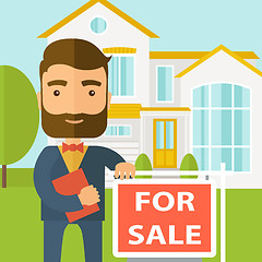 Image showing Real estate agent standing beside the for sale placard.