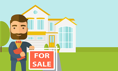 Image showing Real estate agent standing beside the for sale placard.