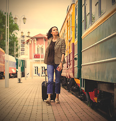 Image showing beautiful middle-aged woman with a suitcase