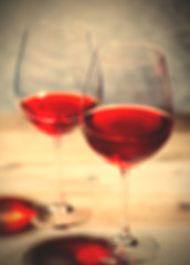 Image showing red wine in two goblets. romantic blur