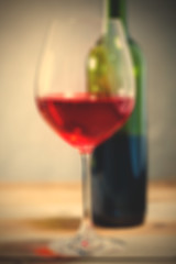 Image showing red wine in glass and green bottle