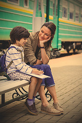 Image showing mother and son on railroad station