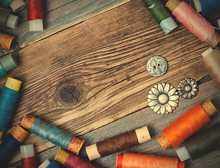 Image showing old reels of varicolored thread and vintage buttons