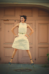 Image showing Smiling beautiful middle-aged woman in the white dress flying