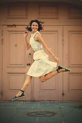 Image showing beautiful brunette  jumped in a white dress