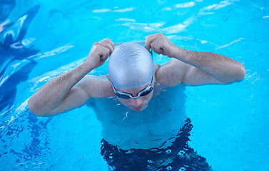 Image showing swimmer excercise on indoor swimming poo