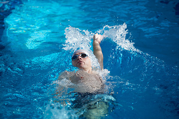 Image showing swimmer excercise on indoor swimming poo