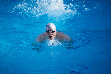 Image showing swimmer excercise on indoor swimming poo