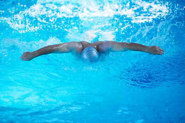 Image showing swimmer excercise on indoor swimming poo