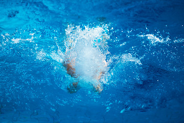 Image showing swimmer excercise on indoor swimming poo