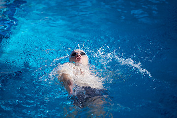 Image showing swimmer excercise on indoor swimming poo