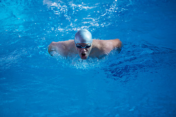 Image showing swimmer excercise on indoor swimming poo