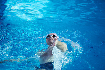 Image showing swimmer excercise on indoor swimming poo