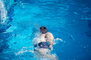 Image showing swimmer excercise on indoor swimming poo