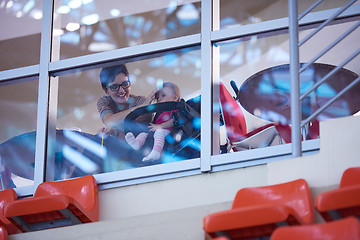 Image showing baby and mom looking trough window