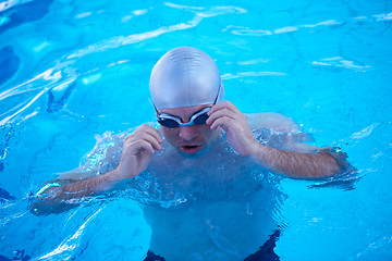 Image showing swimmer excercise on indoor swimming poo