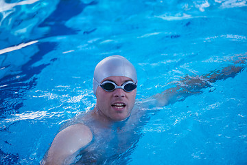 Image showing swimmer excercise on indoor swimming poo