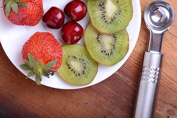 Image showing fruit with cherry, strawberry, kiwi on wooden plate